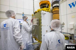 DART team members from the Johns Hopkins Laboratory for Applied Physics in Maryland and the Italian Space Agency carefully placed the LICIACube on the DART spacecraft.  (Image credits: NASA/Johns Hopkins APL/Ed Whitman)