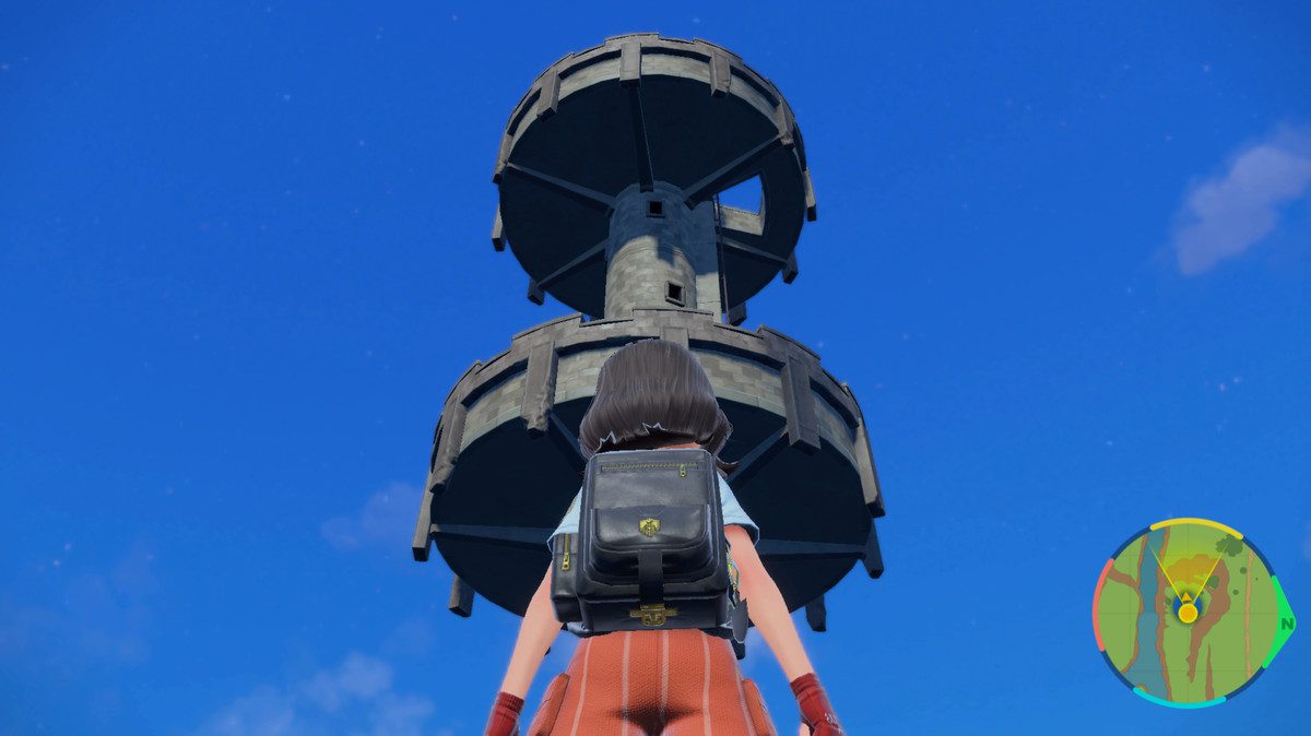 Um treinador Pokémon fica na frente de uma enorme torre de vigia
